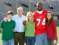 NFL-er Michael Oher with his adopted family, the Tuohys.